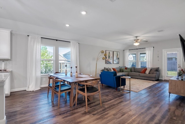 dining room featuring lofted ceiling, recessed lighting, baseboards, ceiling fan, and dark wood-style flooring