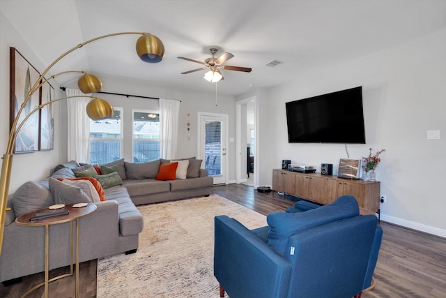 living room featuring dark wood finished floors, visible vents, a ceiling fan, and baseboards