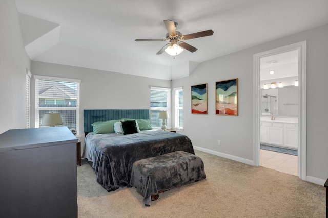 bedroom featuring connected bathroom, a ceiling fan, baseboards, and light carpet