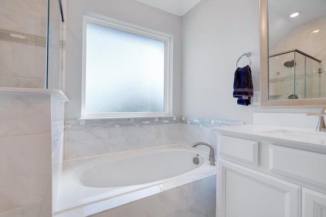 full bathroom featuring a garden tub, a stall shower, and vanity