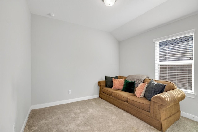 living room with baseboards, carpet floors, and lofted ceiling