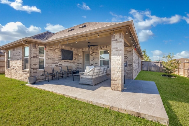 back of property featuring an outdoor living space, a yard, a fenced backyard, and a patio area