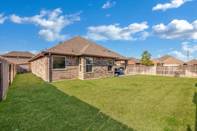 view of yard with a patio area and a fenced backyard