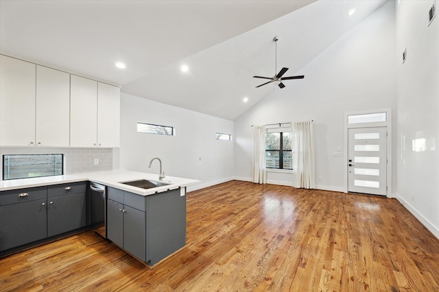 kitchen with dishwasher, a peninsula, gray cabinetry, white cabinetry, and a sink