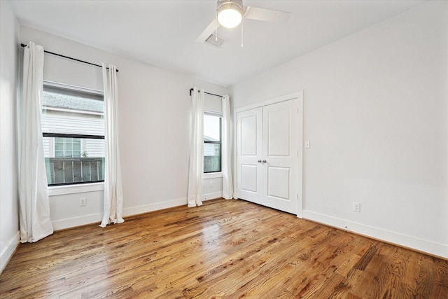 unfurnished bedroom with visible vents, ceiling fan, light wood-style flooring, and baseboards