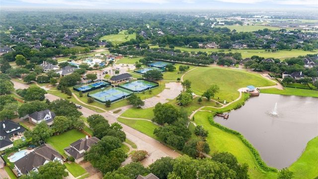 drone / aerial view with golf course view and a water view