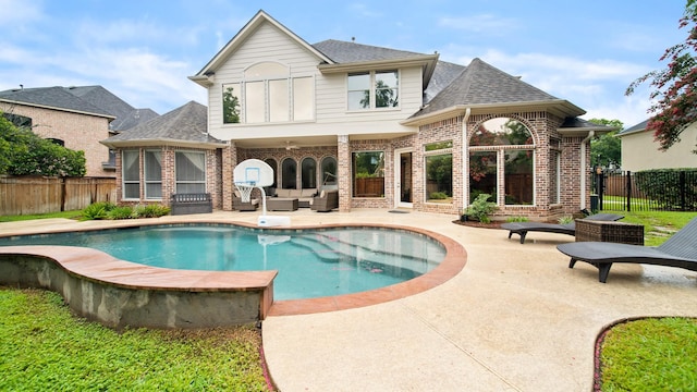 back of house featuring brick siding, a patio, and a fenced backyard