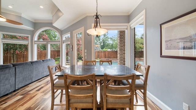 dining room with ornamental molding, recessed lighting, baseboards, and light wood finished floors