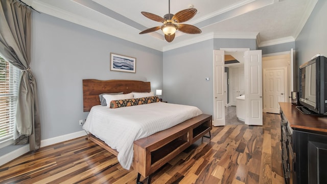 bedroom with ornamental molding, wood finished floors, a raised ceiling, and baseboards