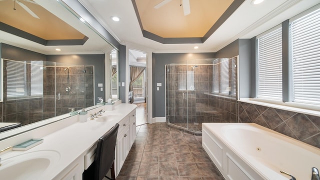 full bath with a ceiling fan, a sink, a shower stall, and ornamental molding