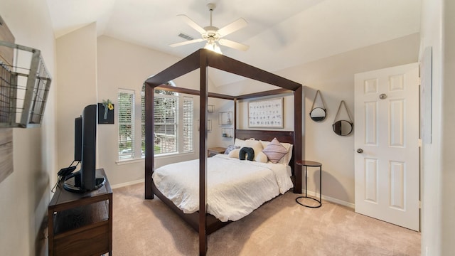 bedroom with light carpet, vaulted ceiling, visible vents, and baseboards