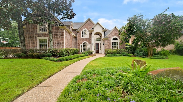 view of front of property with brick siding and a front lawn