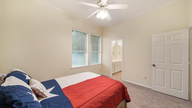 bedroom with baseboards, light colored carpet, ensuite bath, ceiling fan, and crown molding