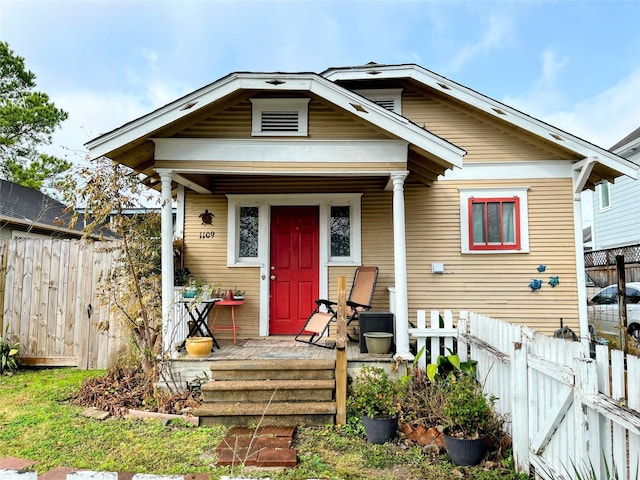 view of front facade with a porch and fence