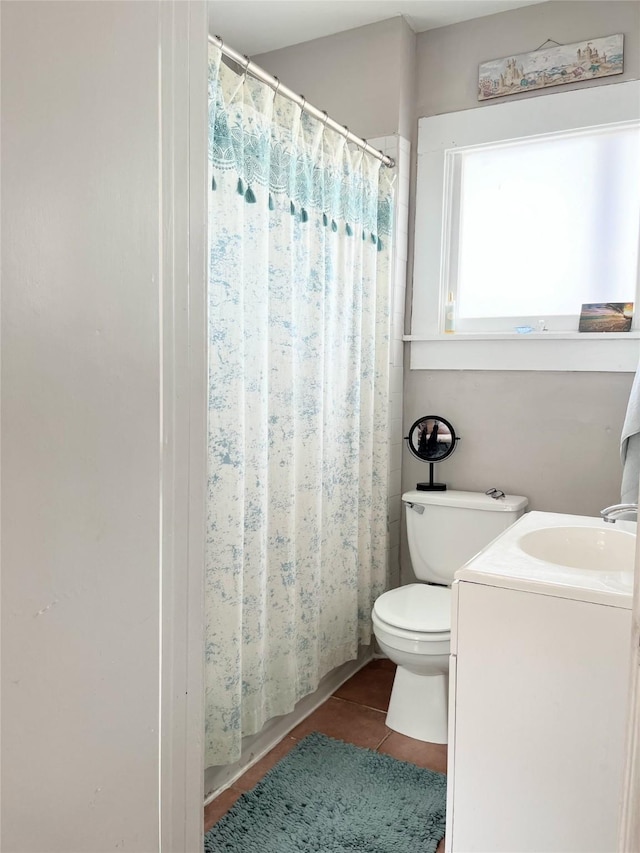 bathroom with tile patterned floors, curtained shower, toilet, and vanity