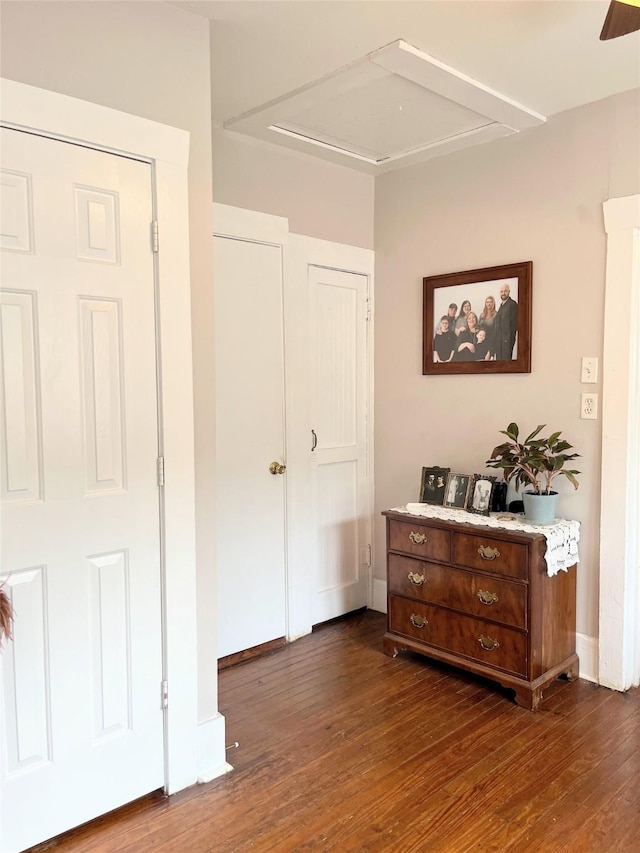 bedroom with dark wood-style floors and baseboards