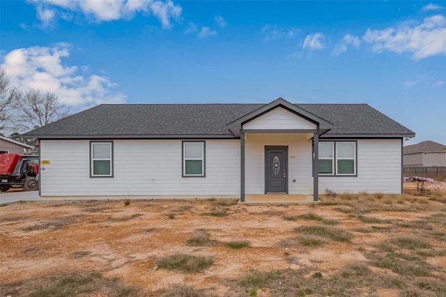 single story home featuring roof with shingles