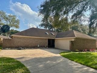 ranch-style home featuring driveway and an attached garage