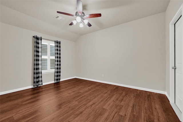 unfurnished room featuring wood finished floors, a ceiling fan, visible vents, vaulted ceiling, and baseboards