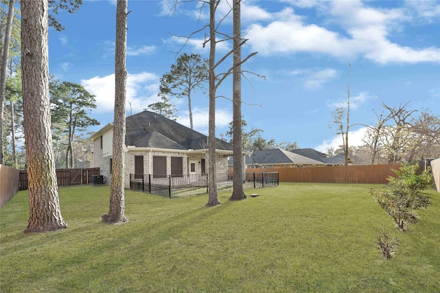 view of yard featuring central AC and a fenced backyard