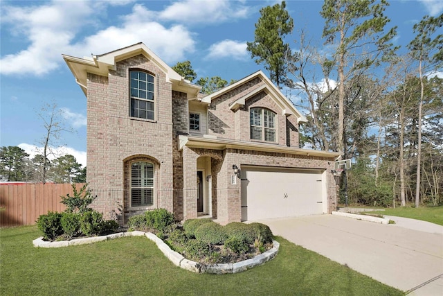 view of front of property featuring driveway, brick siding, a front lawn, and fence