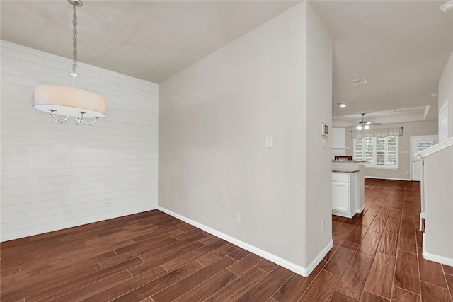 unfurnished dining area featuring wood tiled floor and baseboards