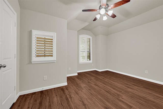 spare room featuring lofted ceiling, ceiling fan, baseboards, and wood finished floors