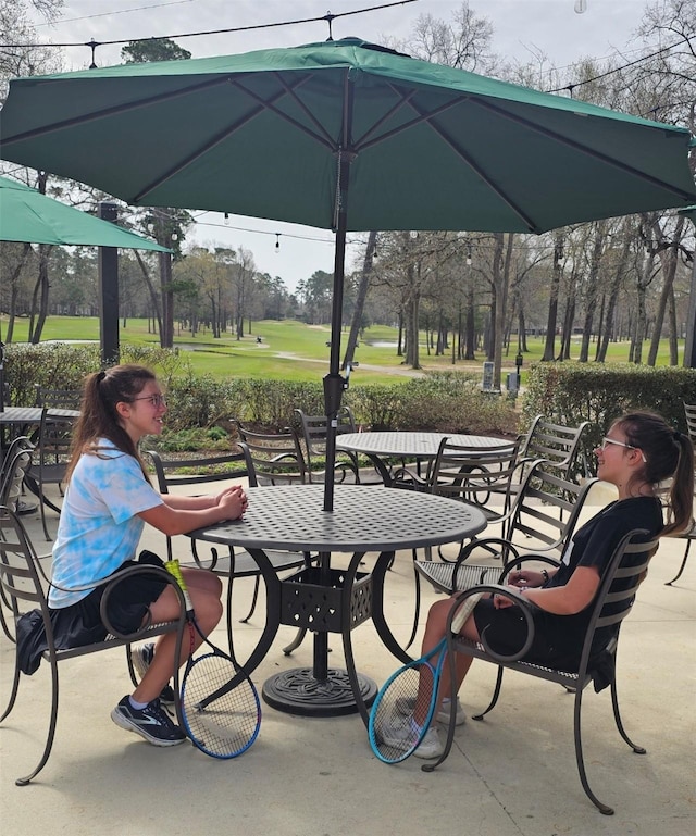 view of community featuring a patio and outdoor dining area