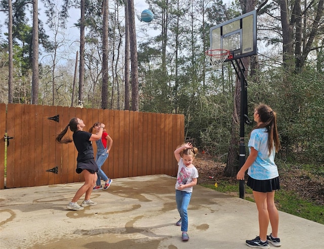 view of basketball court featuring fence