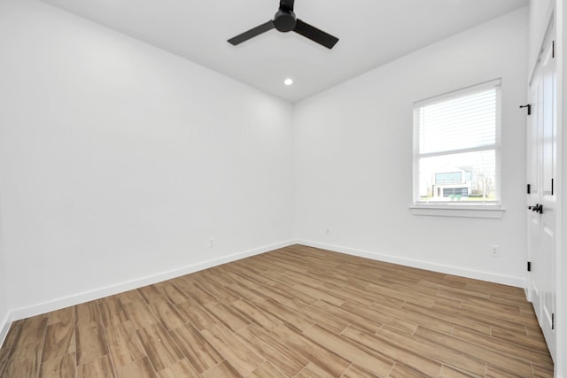 spare room with light wood-type flooring, ceiling fan, baseboards, and recessed lighting