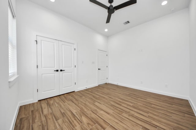 unfurnished bedroom with recessed lighting, visible vents, ceiling fan, wood finished floors, and baseboards