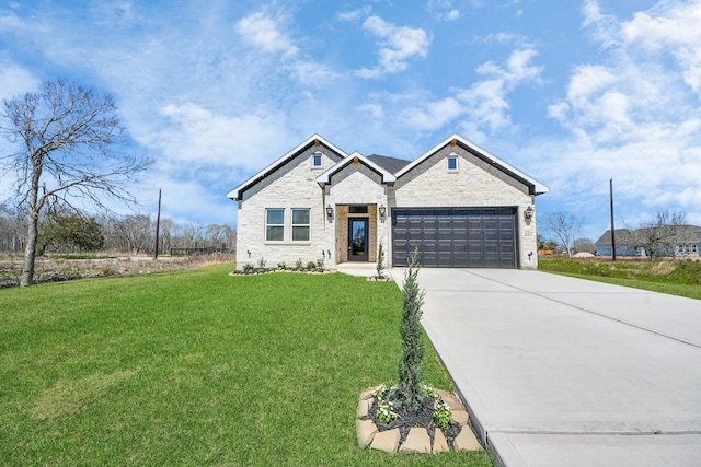 view of front of house with driveway, a front lawn, an attached garage, and stone siding