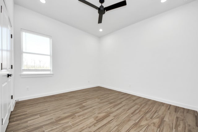 spare room featuring baseboards, ceiling fan, light wood-type flooring, and recessed lighting