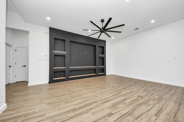 unfurnished living room with a large fireplace, baseboards, light wood-style flooring, and recessed lighting