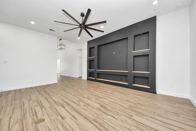 unfurnished living room with built in features, recessed lighting, visible vents, and wood finished floors