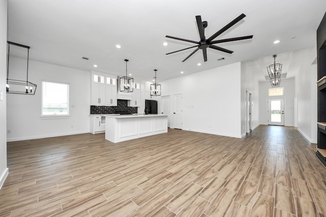 interior space with light wood finished floors, visible vents, and recessed lighting