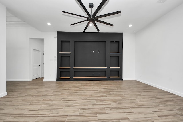 unfurnished living room with wood finish floors, recessed lighting, and baseboards