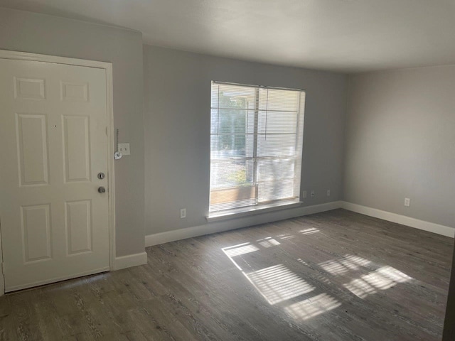 interior space featuring baseboards and wood finished floors