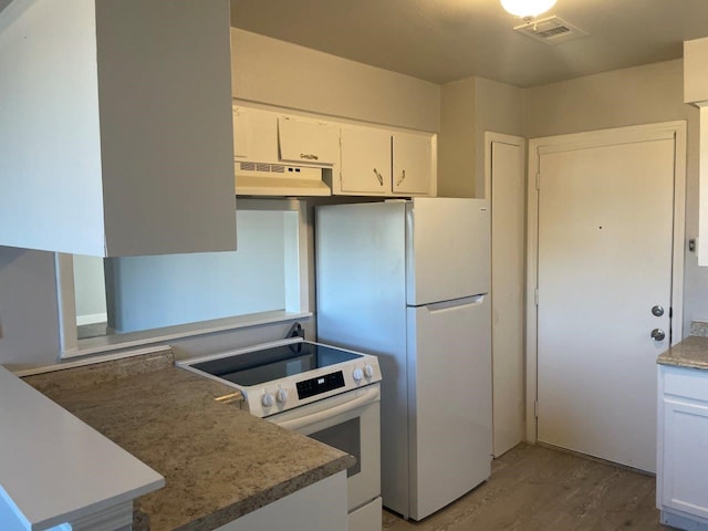 kitchen featuring under cabinet range hood, white appliances, white cabinetry, visible vents, and light wood finished floors