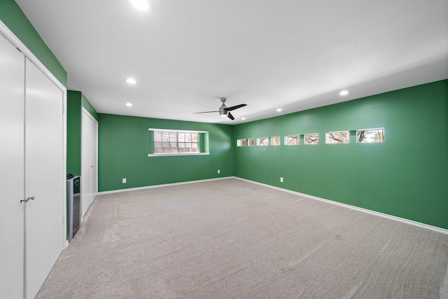 carpeted empty room featuring ceiling fan, baseboards, and recessed lighting