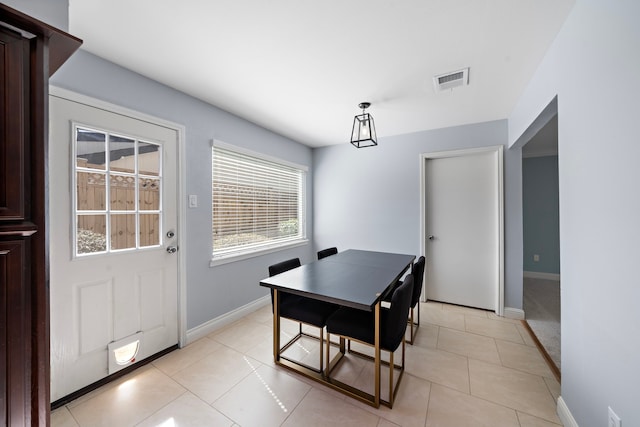 dining space featuring light tile patterned flooring, visible vents, and baseboards