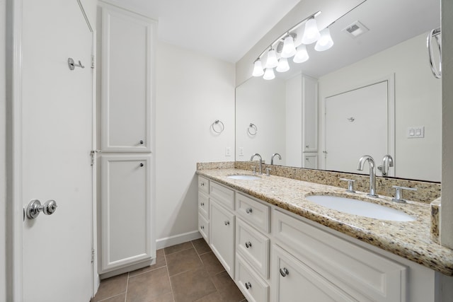 full bathroom with double vanity, tile patterned flooring, a sink, and visible vents