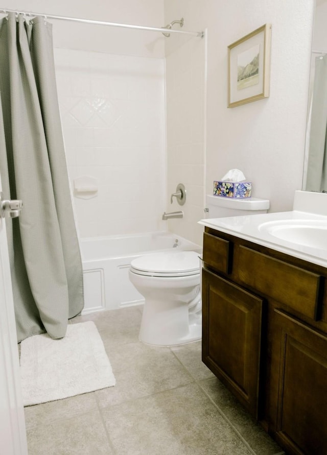 full bath with shower / tub combo, tile patterned flooring, vanity, and toilet