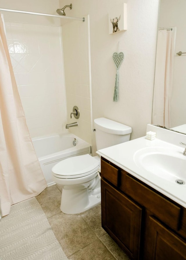 bathroom with tile patterned flooring, shower / tub combo with curtain, vanity, and toilet