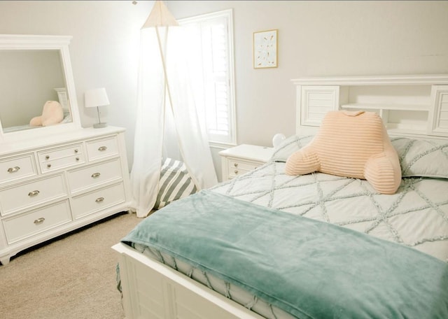 bedroom featuring light carpet