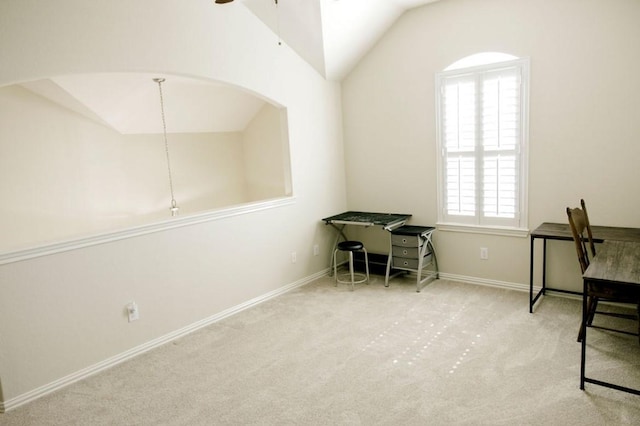 carpeted office with a ceiling fan, vaulted ceiling, and baseboards