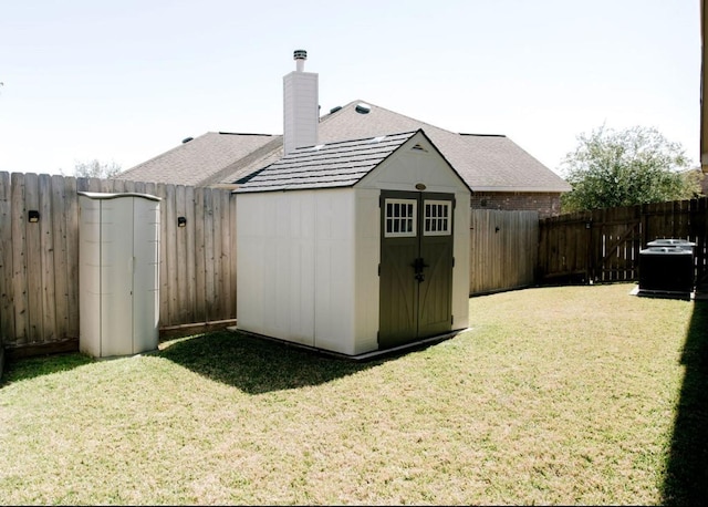 view of shed with central AC unit and a fenced backyard