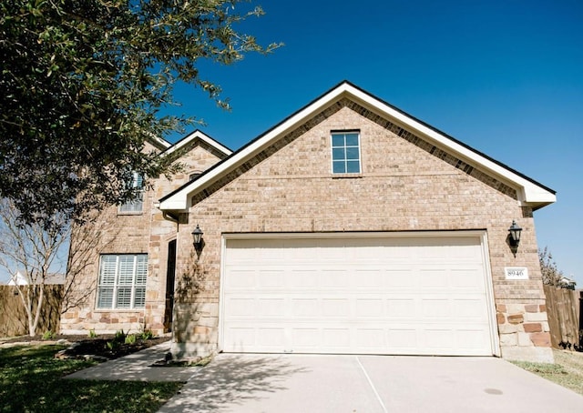 view of front of home with a garage, stone siding, concrete driveway, and brick siding