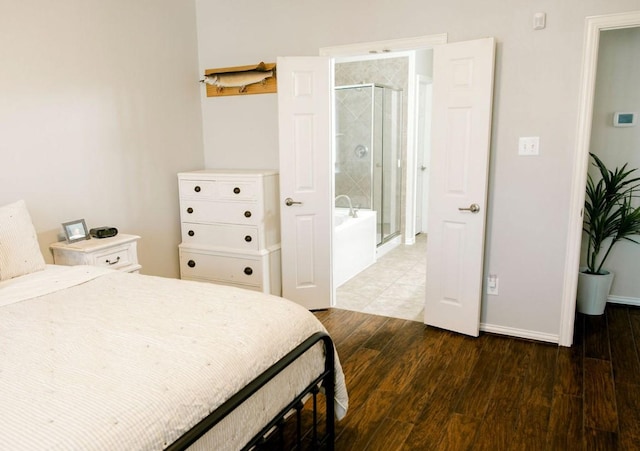 bedroom featuring wood finished floors and baseboards