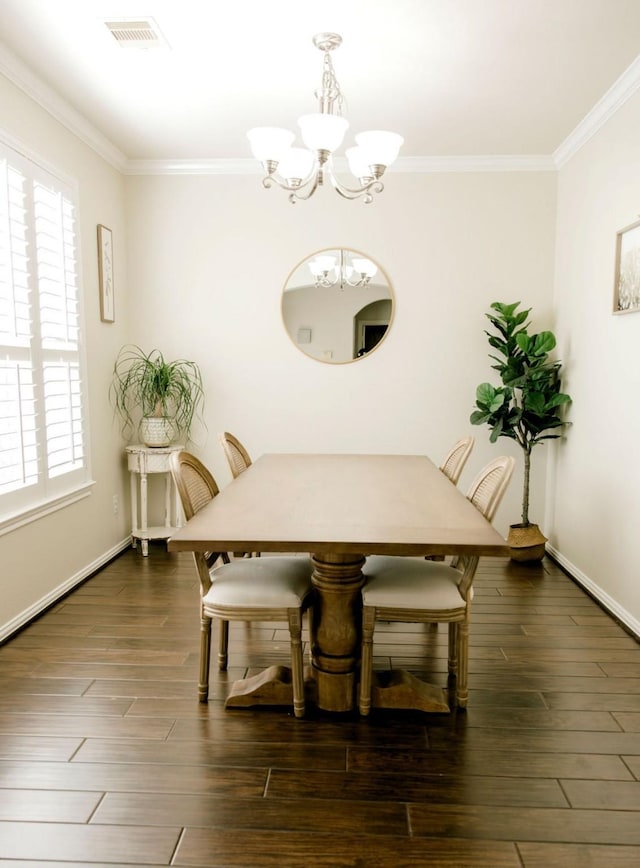 dining area with dark wood-style flooring, crown molding, visible vents, a chandelier, and baseboards